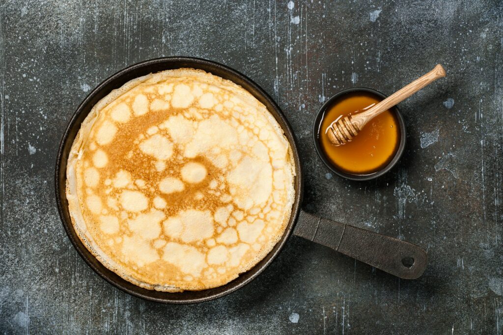 Fascinating Facts About Crepes: A Delicious Journey Through History and Culinary Delight 3 Homemade pancakes on iron pan