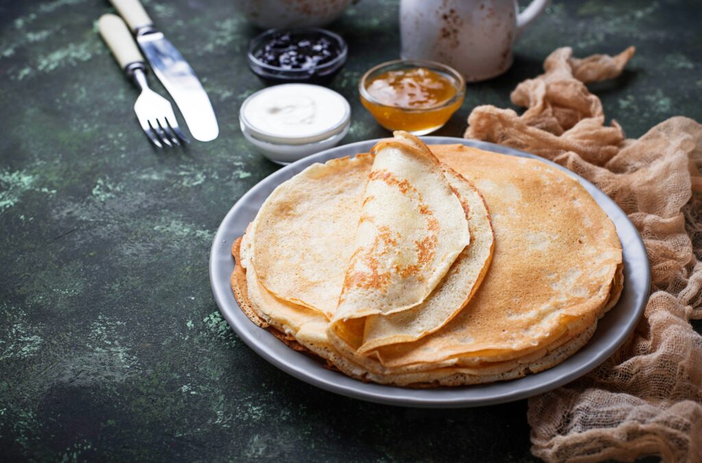 Fascinating Facts About Crepes: A Delicious Journey Through History and Culinary Delight 2 Pancakes crepes with different jam and cream