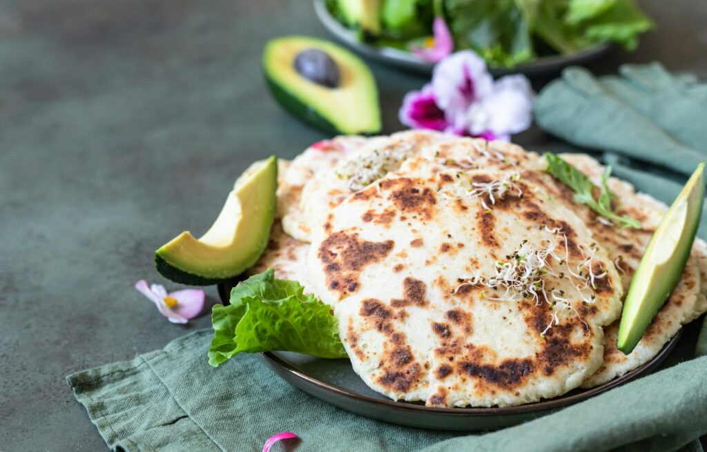 Chapati Nutrition Facts: 11 Surprising Health Benefits 2 Homemade chapati or roti flatbread with green salad mix, avocado and sprouts