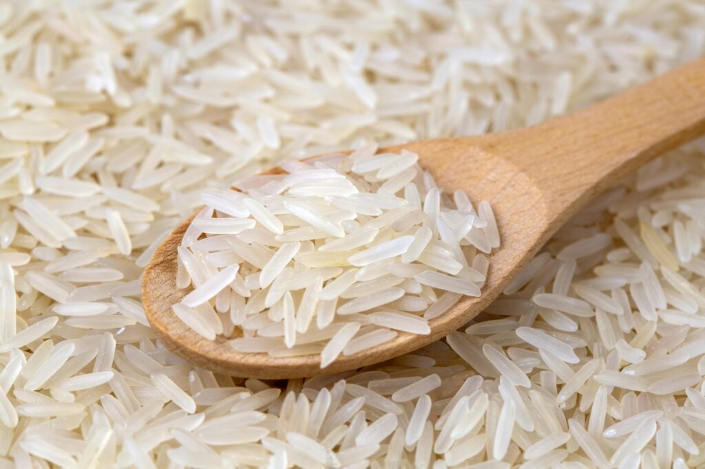 Raw basmati rice in wooden spoon