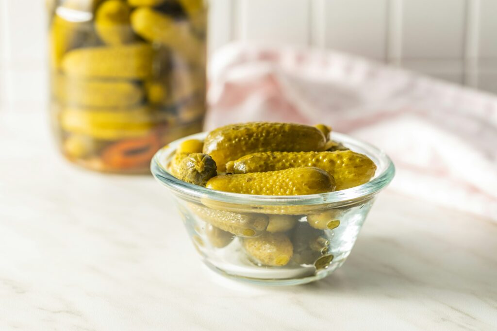 Small pickles. Marinated pickled cucumbers in bowl.